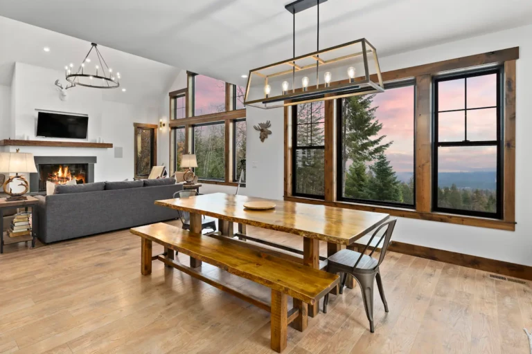 Enjoy the views and a meal together at the live edge dining table which seats 10 people.  In summer, easily access to the deck via the French doors (not shown to right).