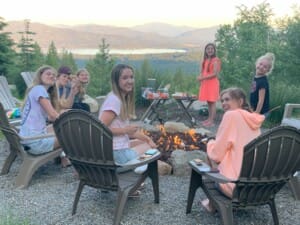 kids crafting smores and laughing around the firepit